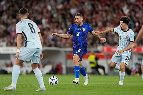 2024-25 Nations League Football Portugal vs Croatia: Portugal's Vitinha, right, chases Croatia's Mateo Kovacic